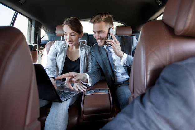 Business colleagues use a laptop to work in the carpeople and technology