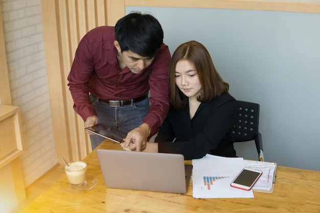 business colleagues using digital tablet in office