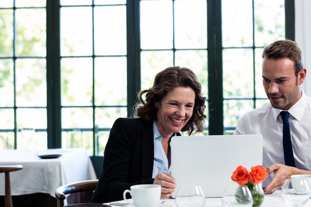 Business colleagues using a laptop while having a meeting 