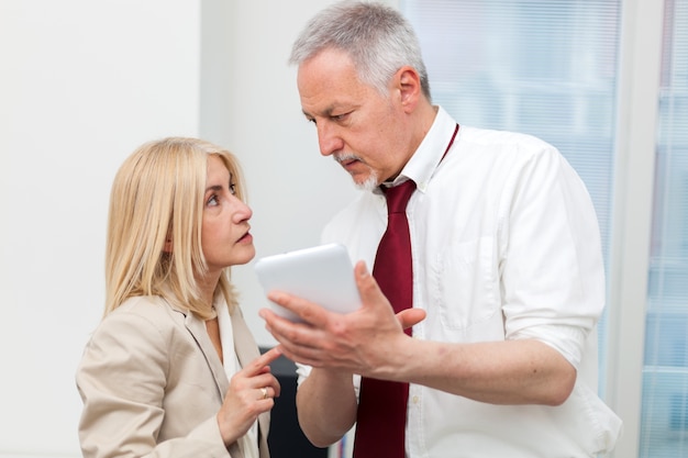 Business colleagues using a tablet in their office