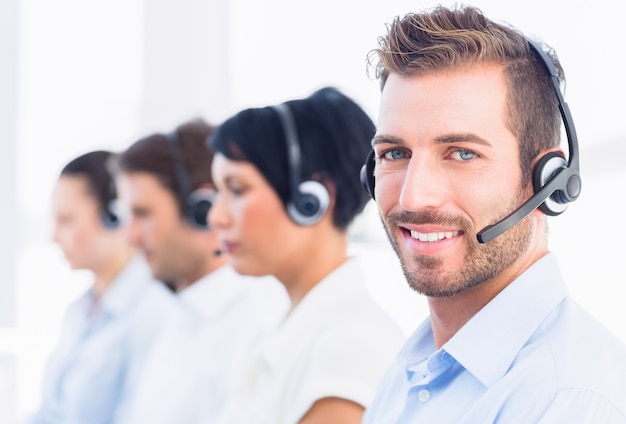 Business colleagues with headsets in a row