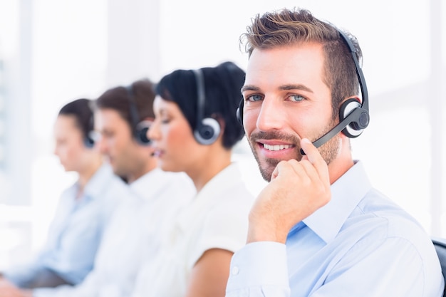 Business colleagues with headsets in a row