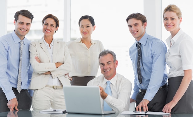 Business colleagues with laptop at desk