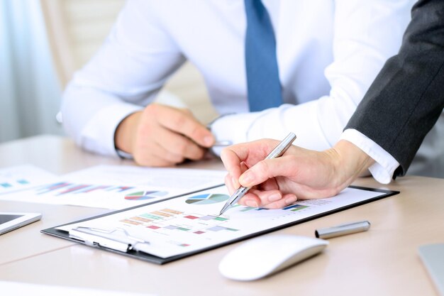 Photo business colleagues working and analyzing financial figures on a graphs