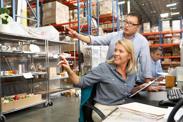 Business Colleagues Working At Desk In Warehouse