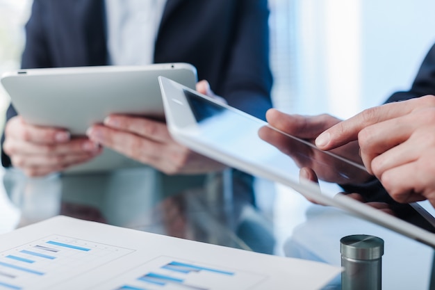 Business collegues working with tablets close-up