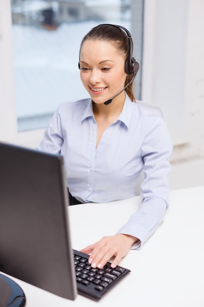 business, communication and call center concept - friendly female helpline operator with headphones