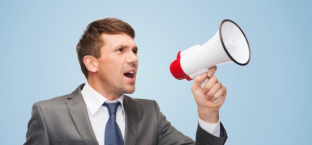 business, communication, hiring, searching, public announcement, office concept - buisnessman with bullhorn or megaphone