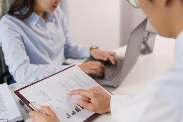 Business concept Business colleague pointing on document to explain financial data to partner