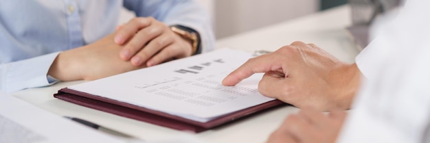 Business concept Business colleague pointing on document to explain financial data to partner