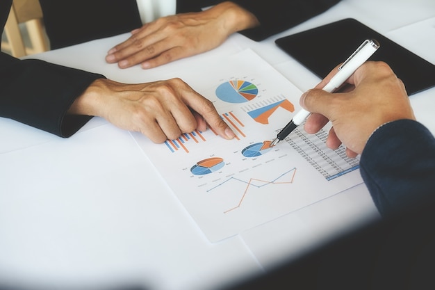 Business concept. Business people discussing the charts and graphs showing the results of their successful teamwork.