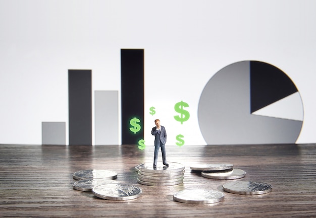 Business concept. Businessman standing on a pile of silver coins.