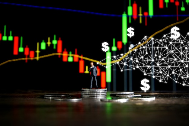 Business concept. Businessman standing on a pile of silver coins.