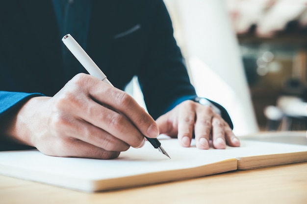 Business concept. Businessman writing notebook.