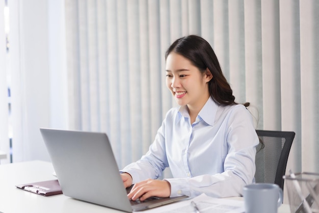 Business concept Businesswoman researching and checking of marketing data on laptop in office