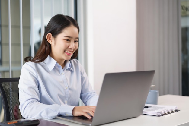 Business concept Businesswoman researching and checking of marketing data on laptop in office