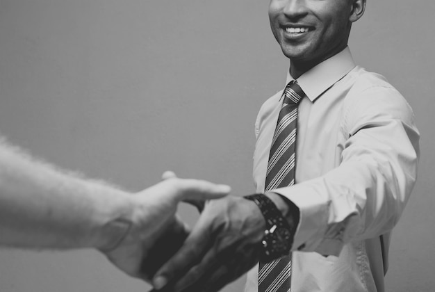 Business concept Closeup of two confident business people shaking hands during a meetingBlack and white