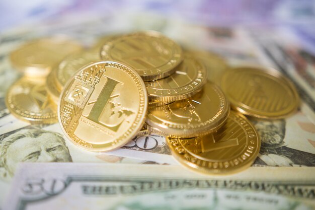 Business concept of crypto currency. Golden Lightcoin on us dollars close up.