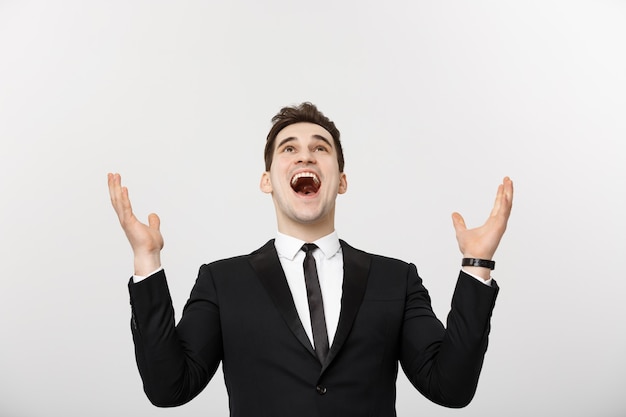 Business Concept: Excited handsome businessman celebration success. Isolated on white