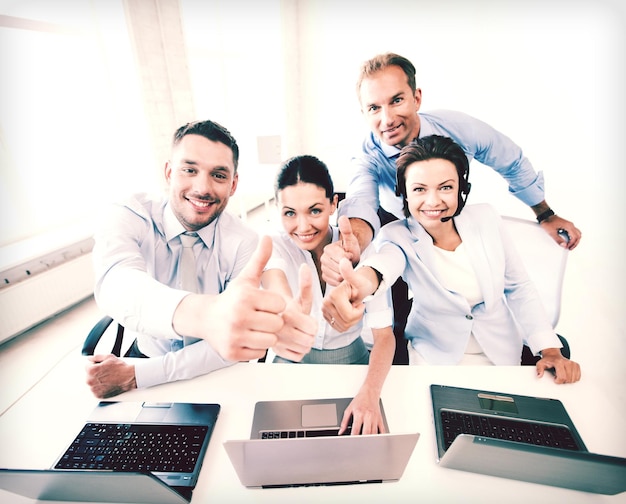 business concept - group of office workers showing thumbs up in call center