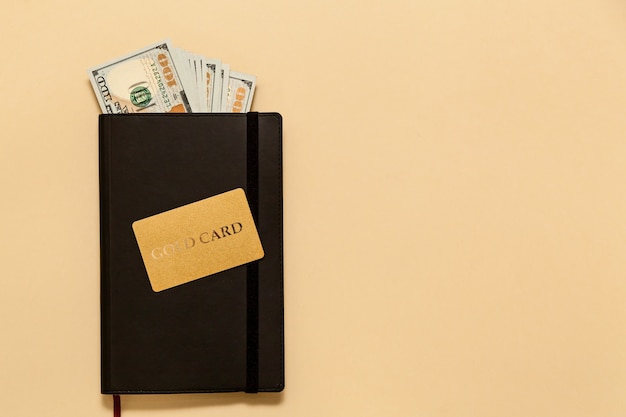 Business concept items on the table diary, dollars, gold card, on a beige background. Bitcoins are a digital currency, the global market for trade and exchange of money.