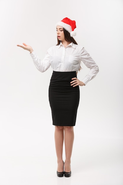 Business concept  modern caucasian business woman in the white  wall holding hand onside presenting product