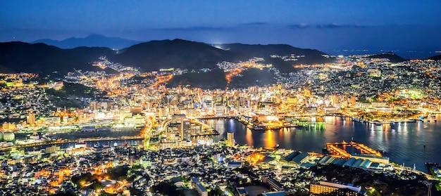 Business concept, modern cityscape of nagasaki dusk from mount inasa, aerial view, copy space