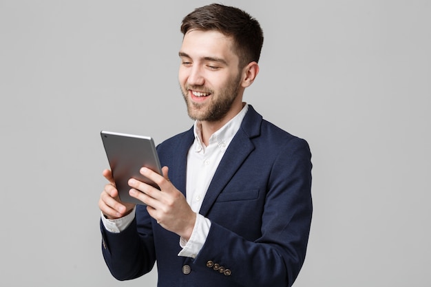 Business Concept - Portrait Handsome Business man playing digital tablet with smiling confident face. White Background. Copy Space.