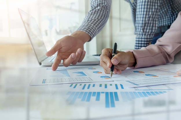 Business concept. Rows of coins for finance and banking concept with business man and woman. A metaphor of international financial consulting.