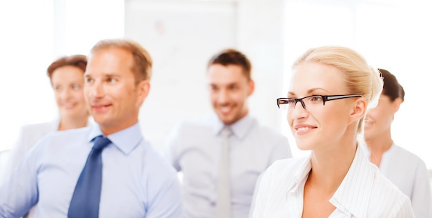 business concept - smiling businessmen and businesswomen on conference