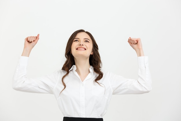 Business concept young happy businesswoman with hands in the air is celebrating success