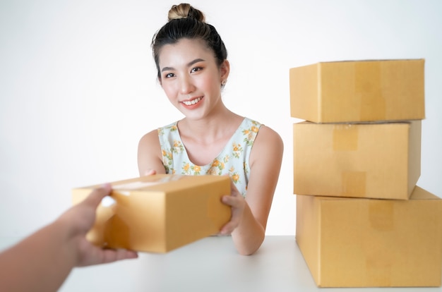 business concept.Young people are packing their packages to deliver to customers.