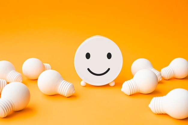 Business concepts with lightbulb and smiley faceinspiration and motivationbrainstorming and sharing ideas