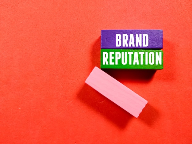Photo business concepttext brand reputation with colored wooden block on red background