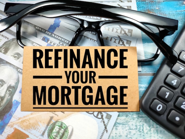 Business conceptText REFINANCE YOUR MORTGAGE with banknoteglasses and calculator