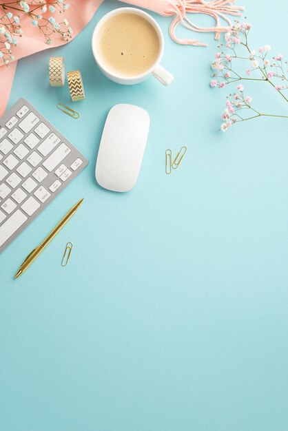 Business conceptTop view vertical photo of cup of coffee keyboard computer mouse golden pen clips adhesive tape gypsophila flowers and pink plaid on isolated pastel blue background with copyspace