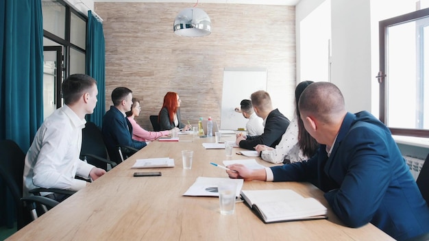 A business conference in the office A man drawing a charts on the board