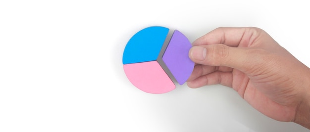 Business connecting piece of multi colored pie wood chart in
hand