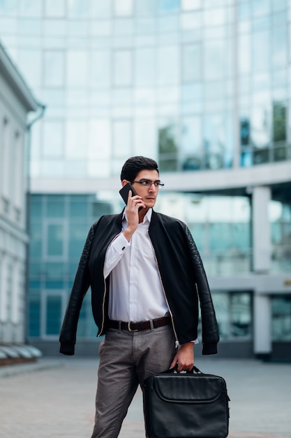 Business contacts. man talking on the phone outside. busy lifestyle. city life