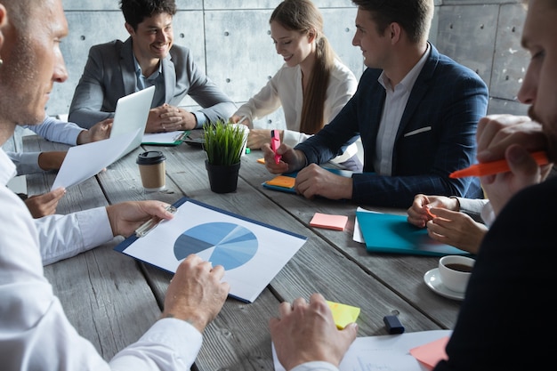 Business corporate management planning team concept, people sitting around office table and working with financial data reports