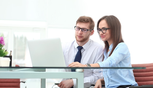 Business couple looking at laptop screen