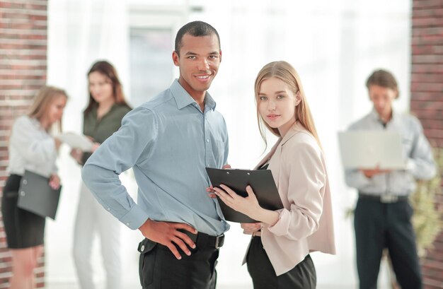 Business couple standing in a modern office