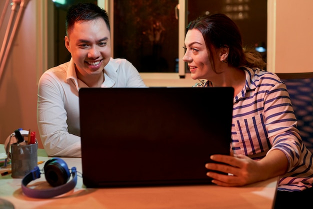 Business couple working on laptop at office