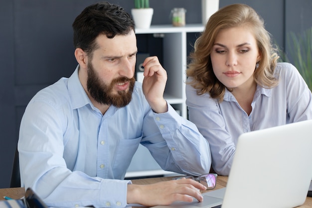 business couple working together on project at modern startup office