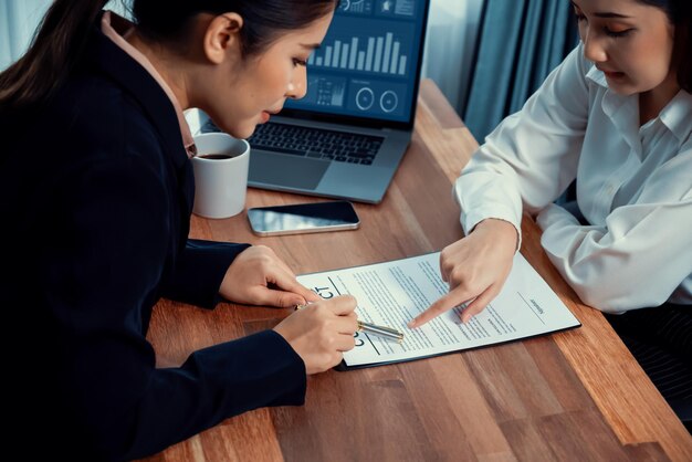 Photo business deal meeting businesswomen reviewing terms and condition equilibrium