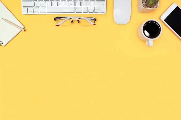 business desk with computer on yellow