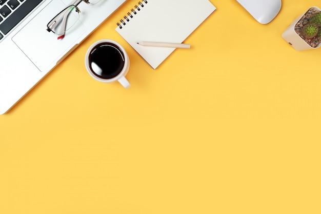 business desk with computer on yellow