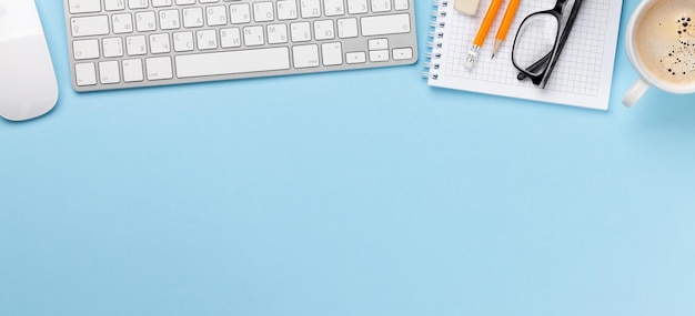 Business desk workplace and office objects over blue backdrop Top view flat lay with copy space for your text