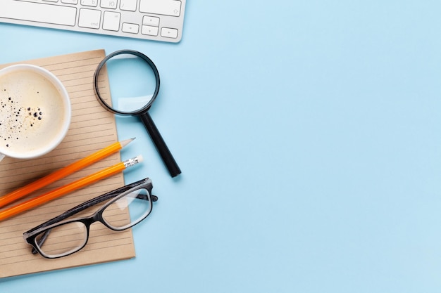 Business desk workplace and office objects over blue backdrop Top view flat lay with copy space for your text