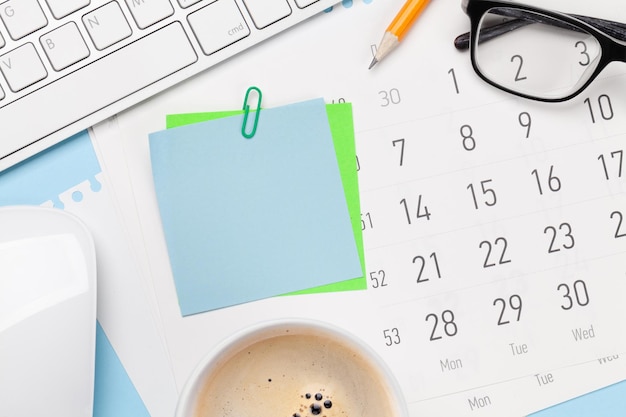 Photo business desk workplace and office objects over blue backdrop top view flat lay with copy space for your text